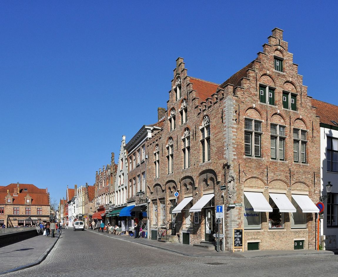 A sunny street of stepped-gable brick houses in Bruges