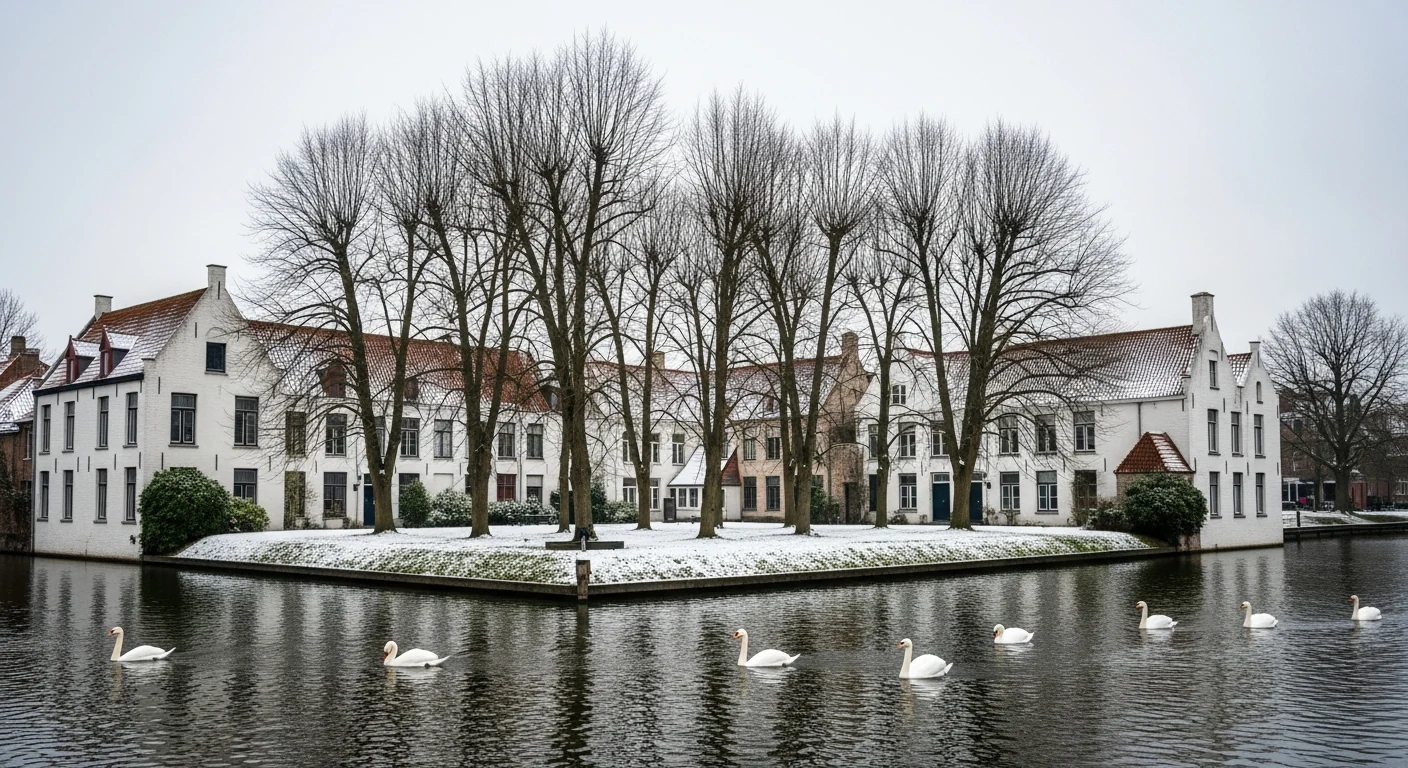 Snow-dusted Beguinage in Bruges with swans on the water